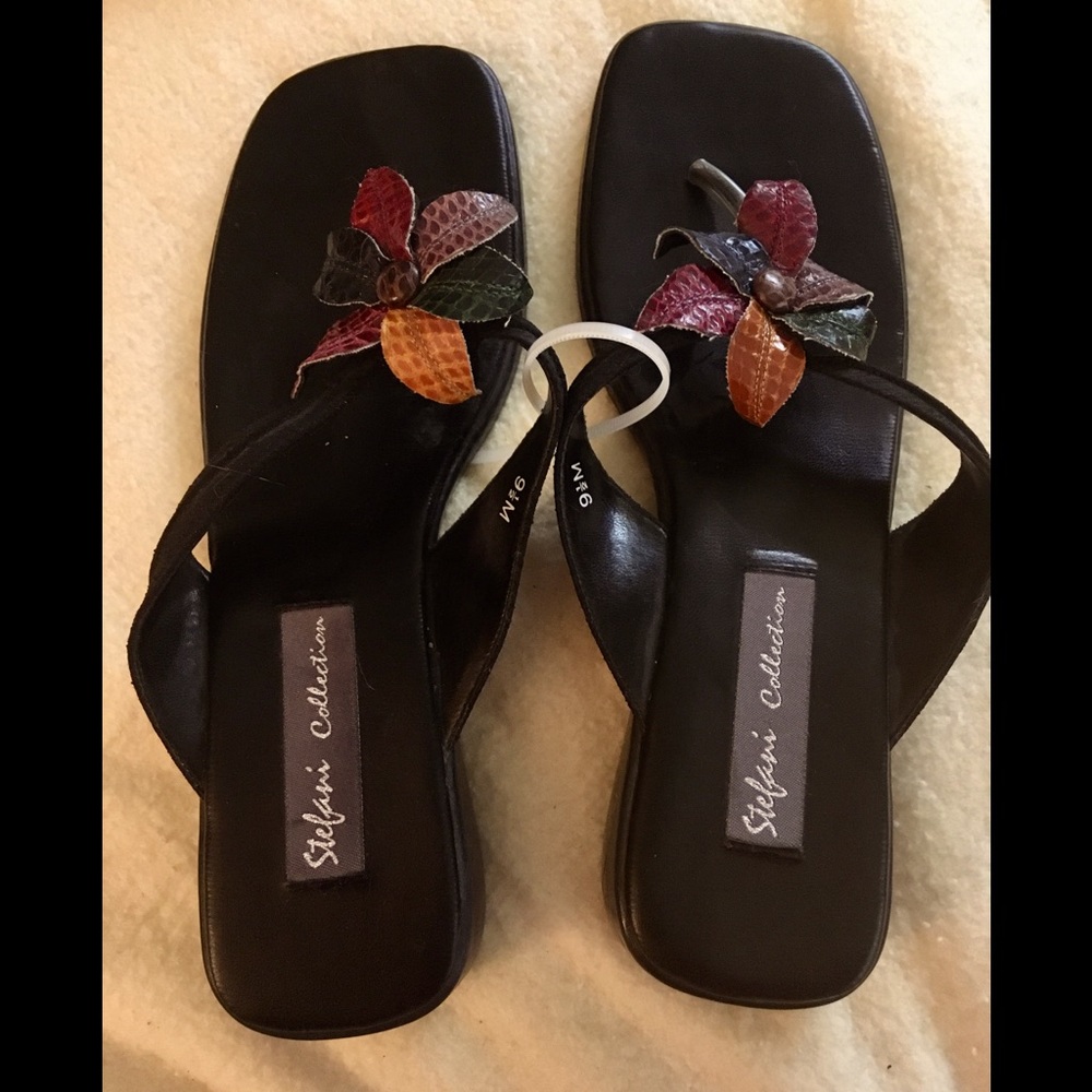 NWT BLACK SLIP ON SANDALS WITH FLOWER APPLIQUÉ. 1 1/2” heel. Size 9 1/2 M